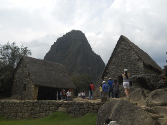 Machu Picchu, grupo de casitas con la piedra
                    sagrada 01